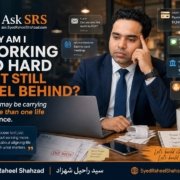 Syed Raheel Shahzad at a desk with laptop, bills and reminders asking why hard work still feels like falling behind